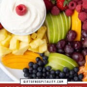 platter of assorted chopped fruit with a fluffy white marshmallow cream dip in the middle.