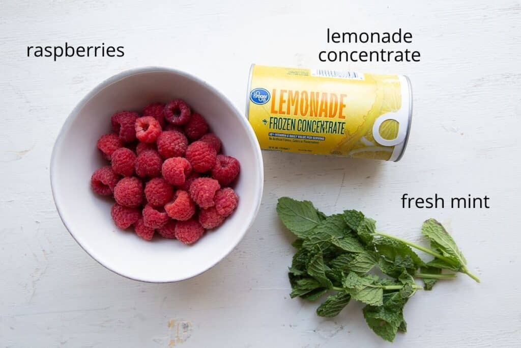 raspberry lemonade ingredients on a white table.