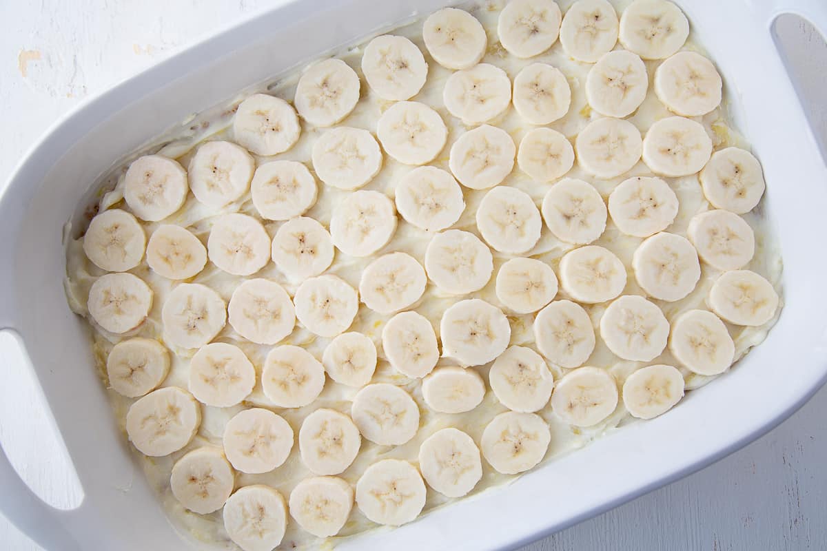 sliced bananas in a 13x9 inch white pan.