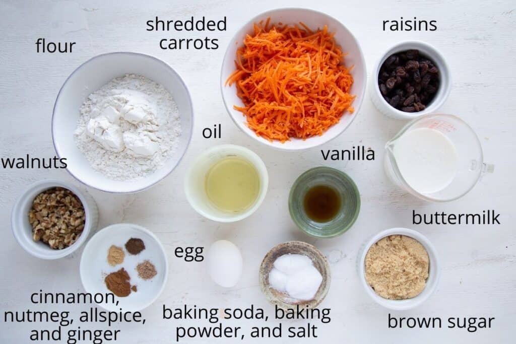 carrot muffin ingredients on a white table.