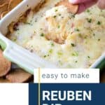 hand scooping reuben dip from a casserole dish.