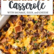 egg casserole topped with cheese and sausage in a casserole dish.