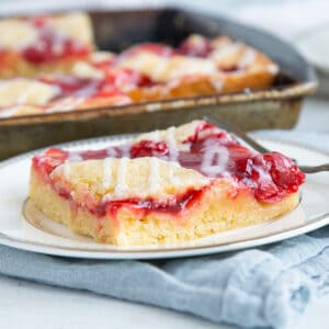 slice of cherry coffee cake on a white plate.