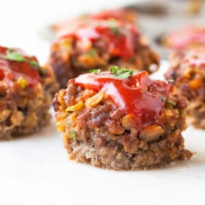 meatloaf in the shape of a muffin with ketchup and parsley on top.