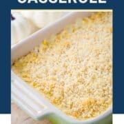 cheesy corn casserole in a green casserole dish.