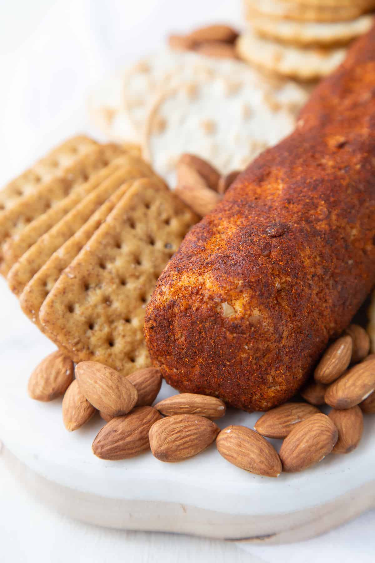 cheese roll with almonds and crackers.