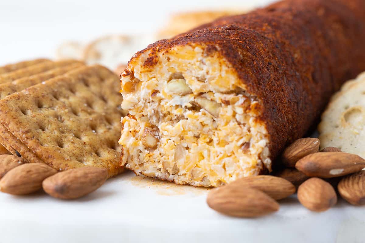 cross section of a cheese roll with crackers and almonds.