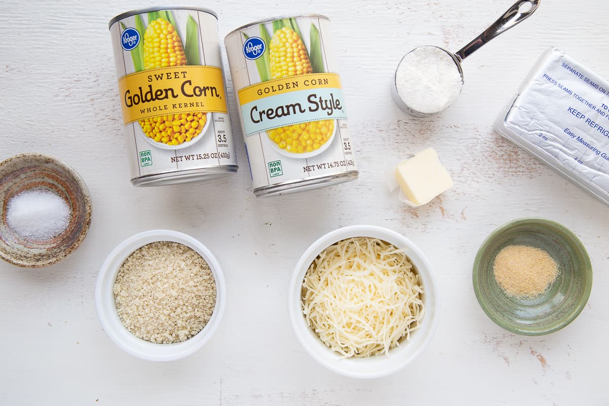 ingredients for cheesy corn casserole on a white table.