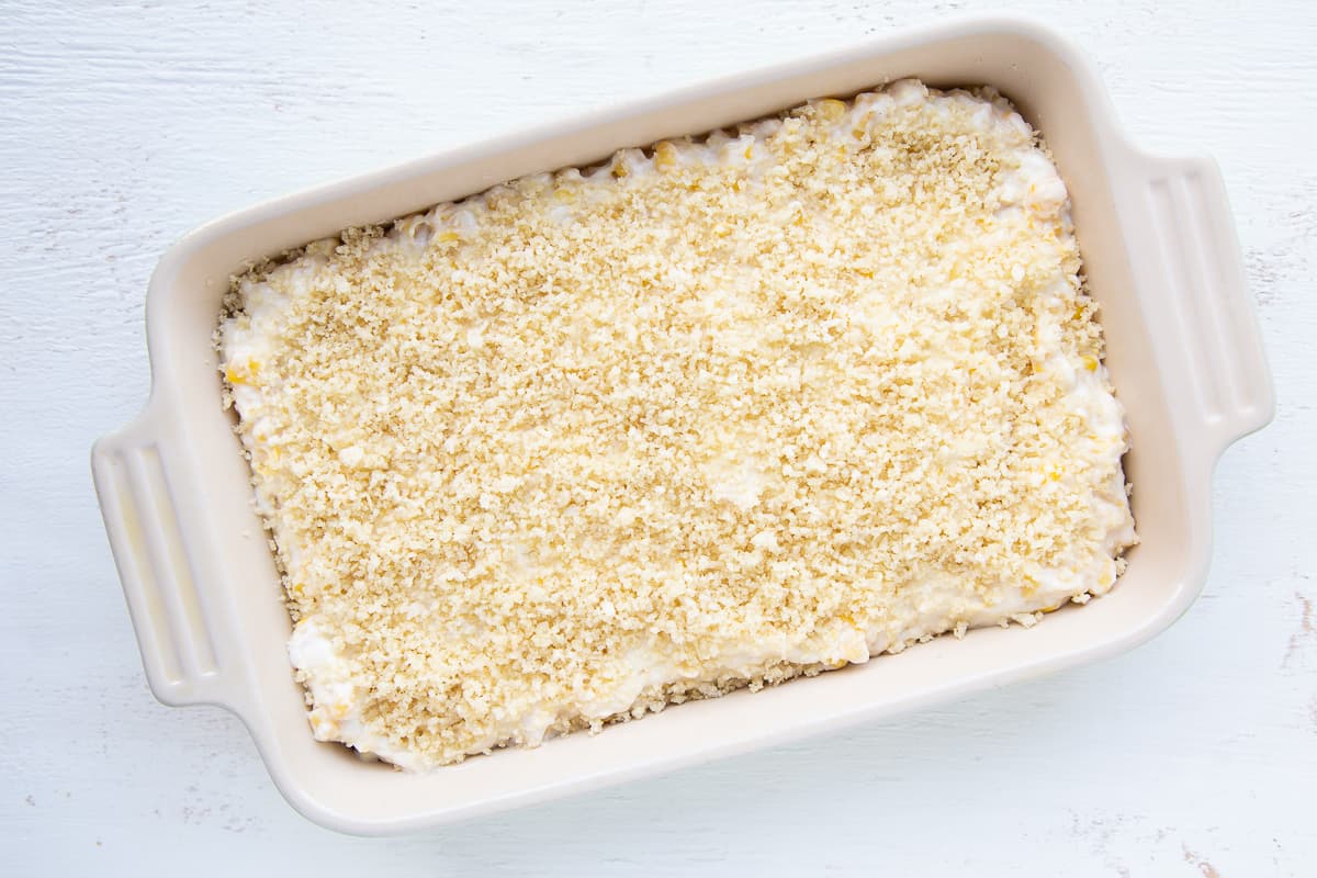 unbaked corn casserole in a white casserole dish.