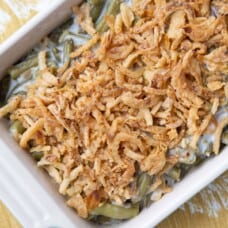 green bean casserole topped with fried onions in a casserole dish.