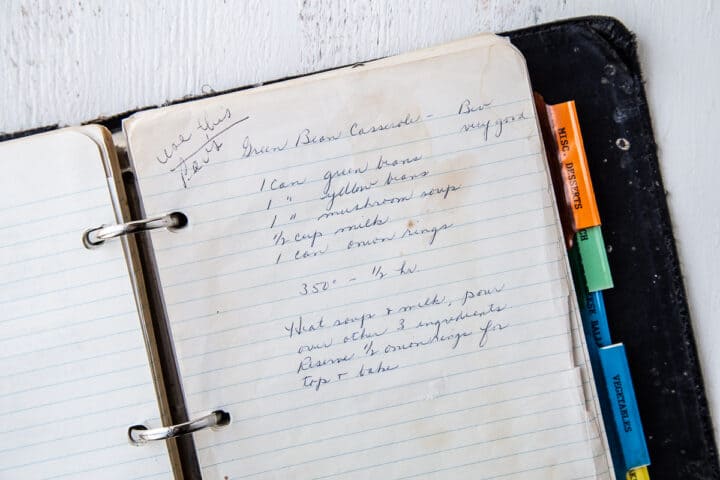 handwritten recipe for green bean casserole on lined notebook paper.