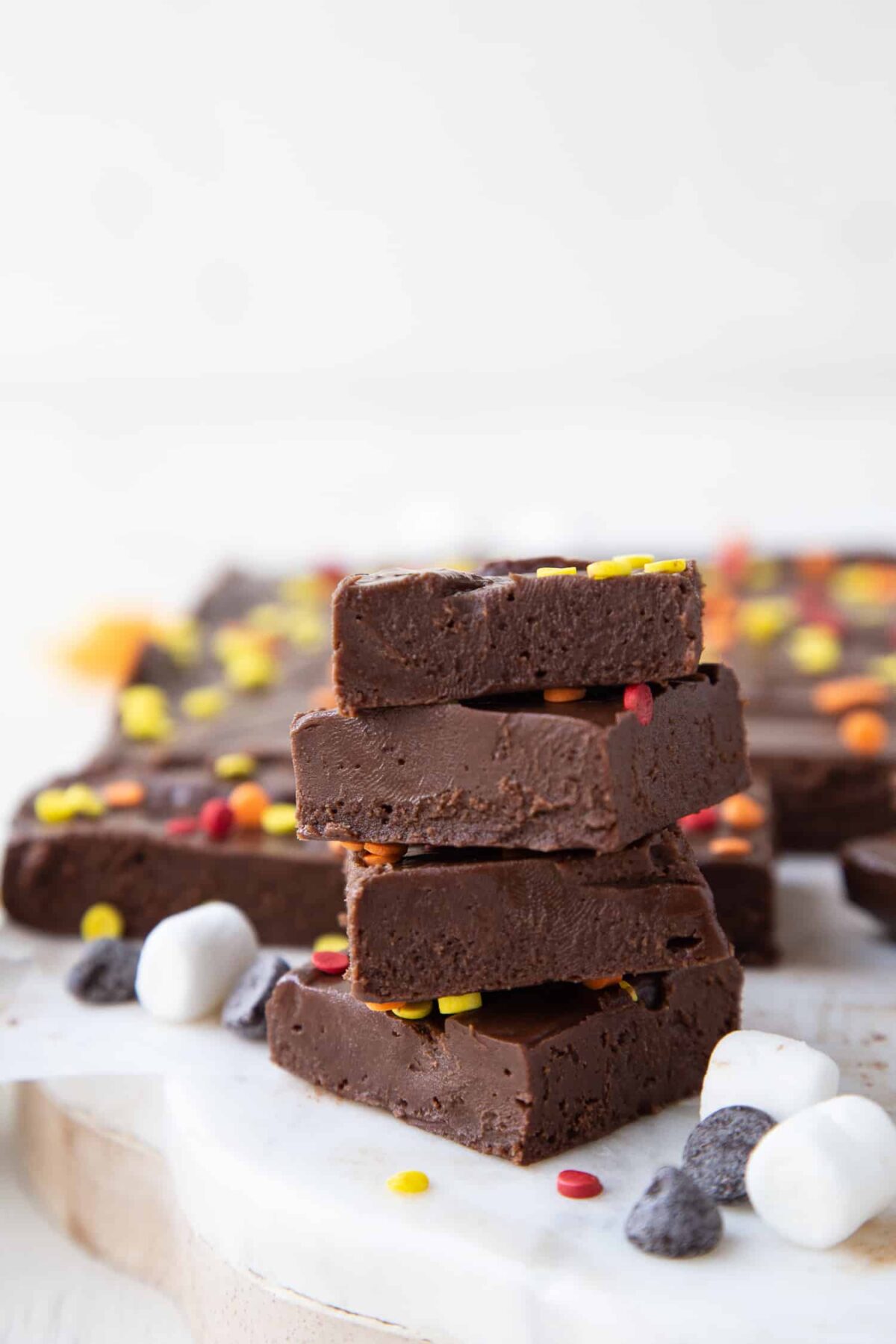 stack of marshmallow fudge squares on a white platter.