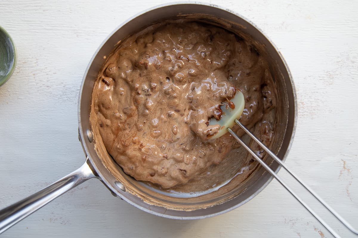 cooked sugar, pecans, and baking soda combined in a saucepan.