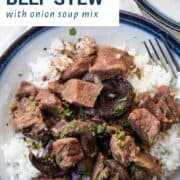 crockpot beef stew over rice on a white and blue plate.