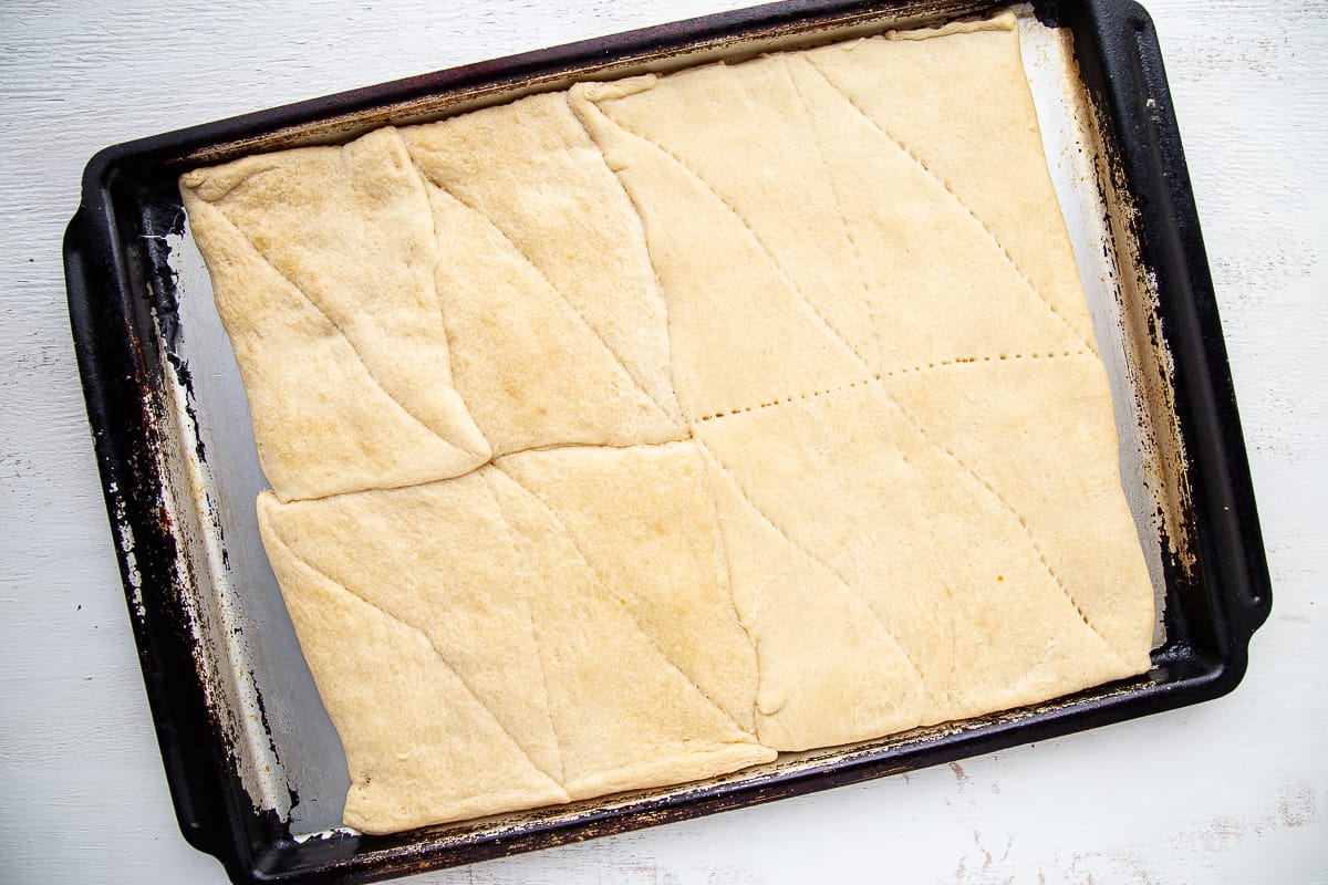 cooked crescent roll dough on a sheet pan.