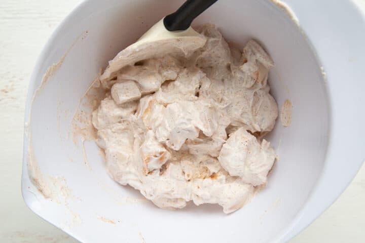 chicken with sour cream and spices in a white bowl.