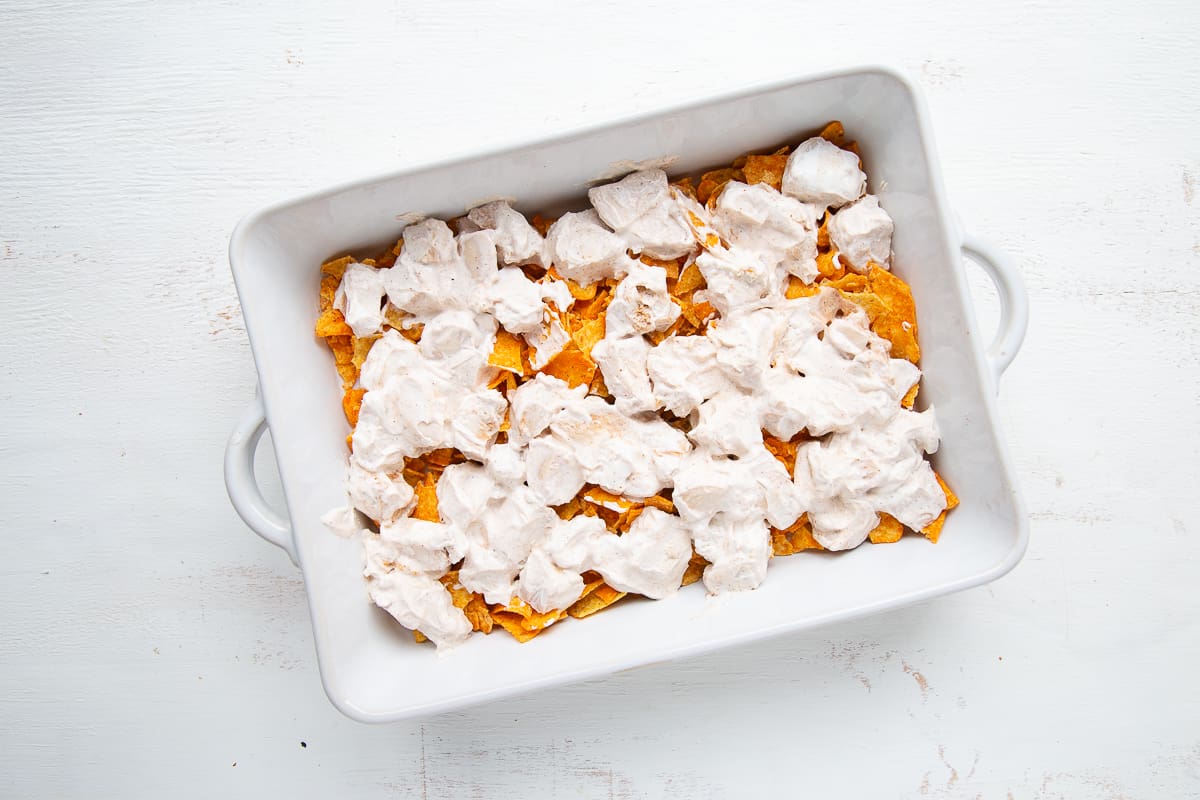 doritos and chicken in a white casserole dish.