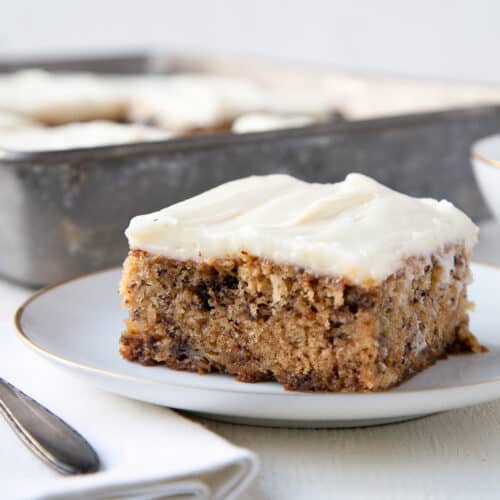 slice of old fashioned banana cake on a white plate.