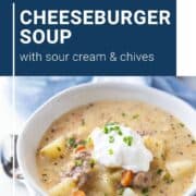 bowl of cheeseburger soup with sour cream and chives.