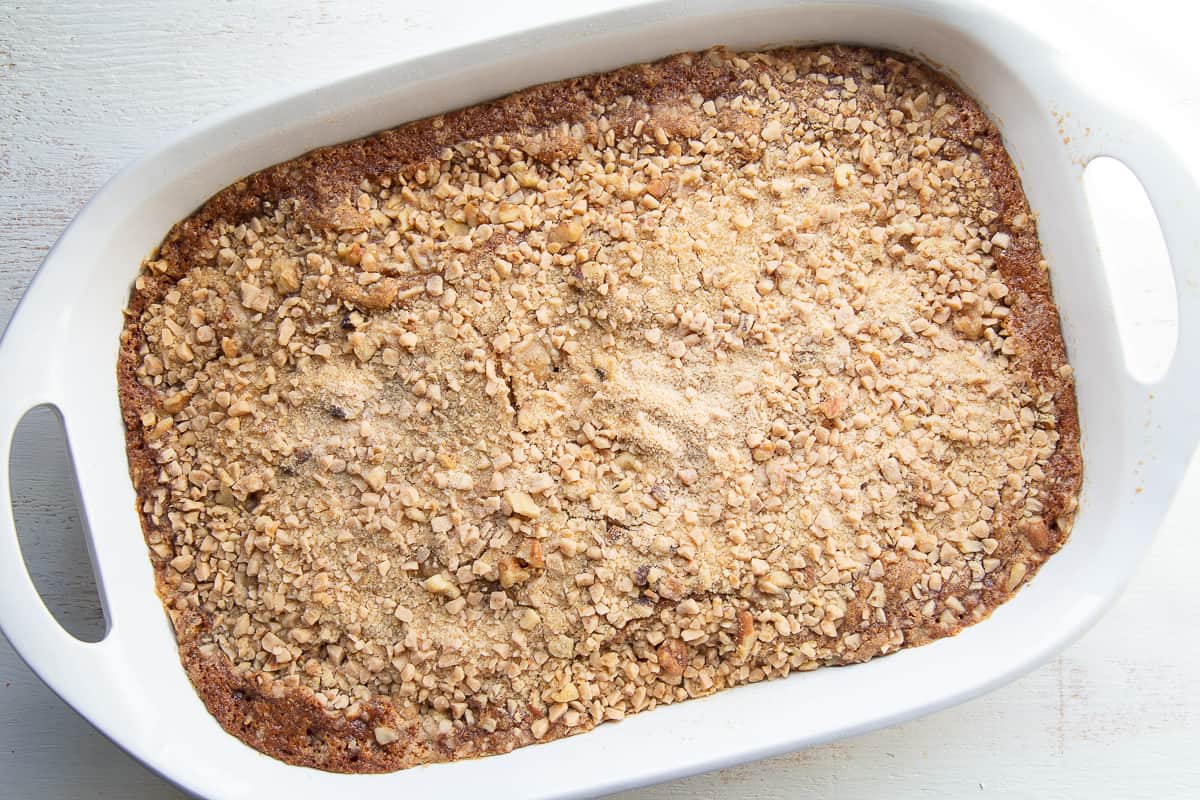 cooked heath bar cake in a white pan with handles.