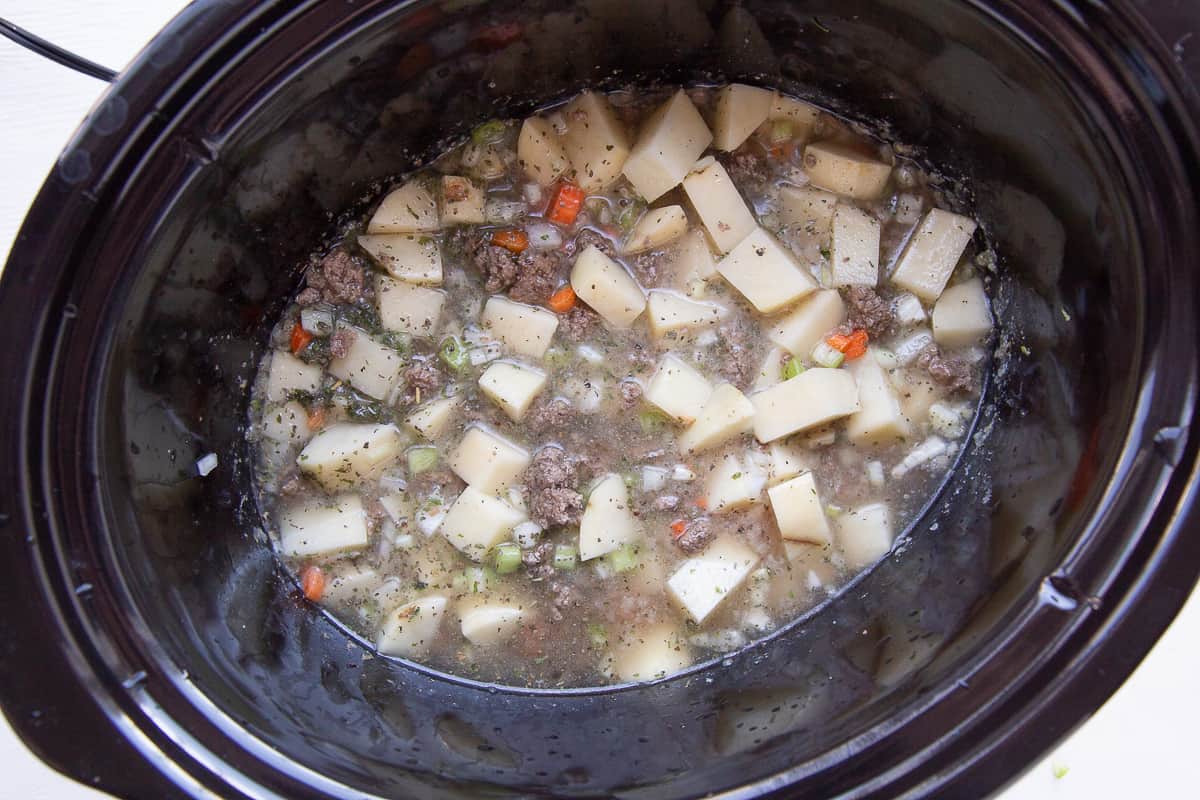 beef, potatoes, and broth in a crockpot.