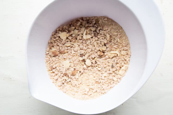 nuts, toffee, and crumble in a white bowl.