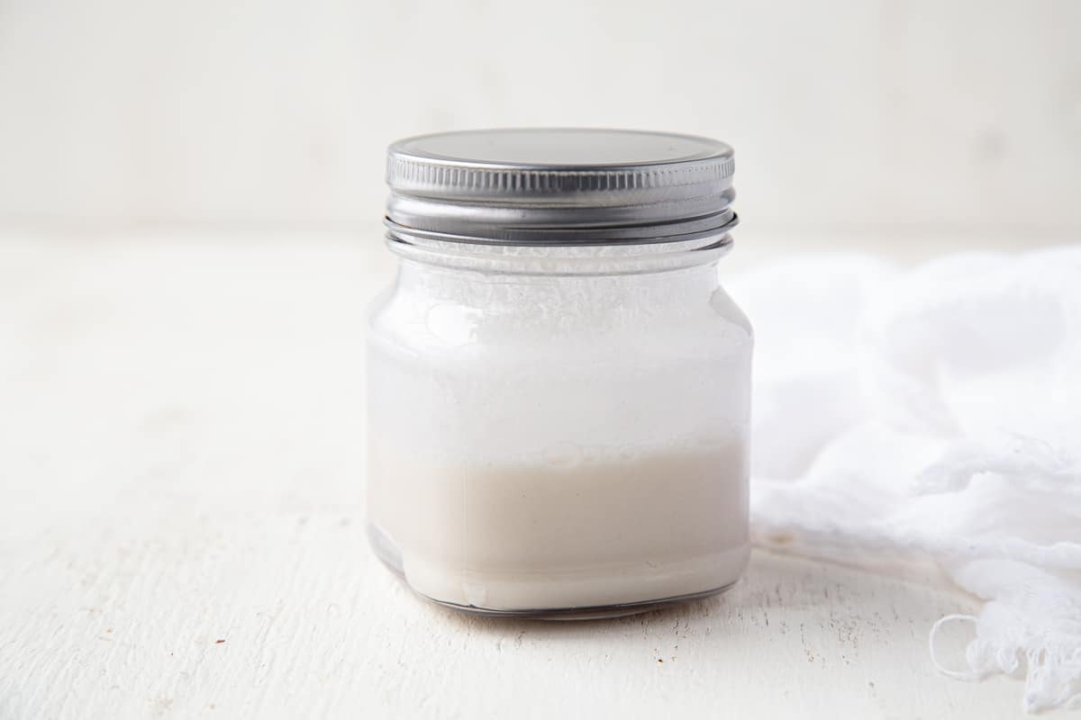 flour and water mixture in a glass jar with a metal lid.