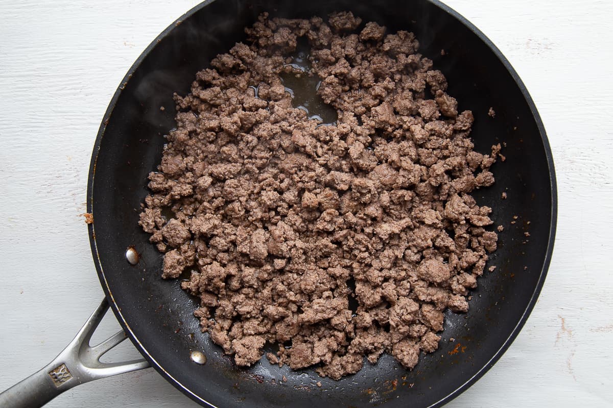 ground beef in a black skillet.