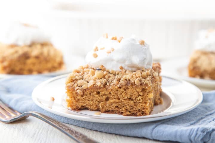 slice of cake topped with heath bar bits and whipped cream.