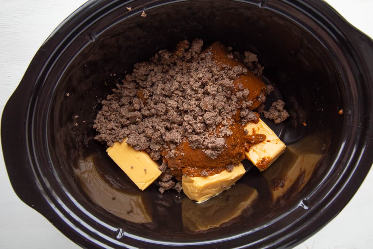 chili, velveeta, and ground beef in a crockpot.