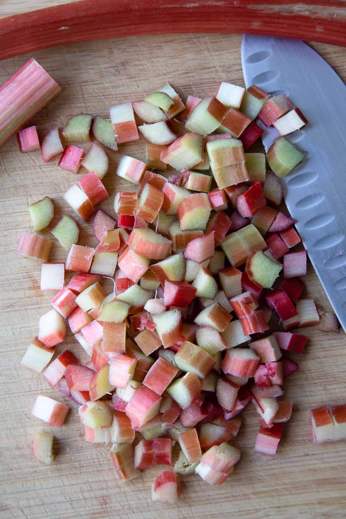 chopped rhubarb on a wooden cutting board.