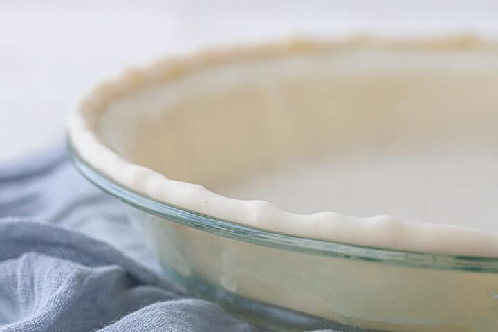 unbaked pie crust in a glass pie dish.