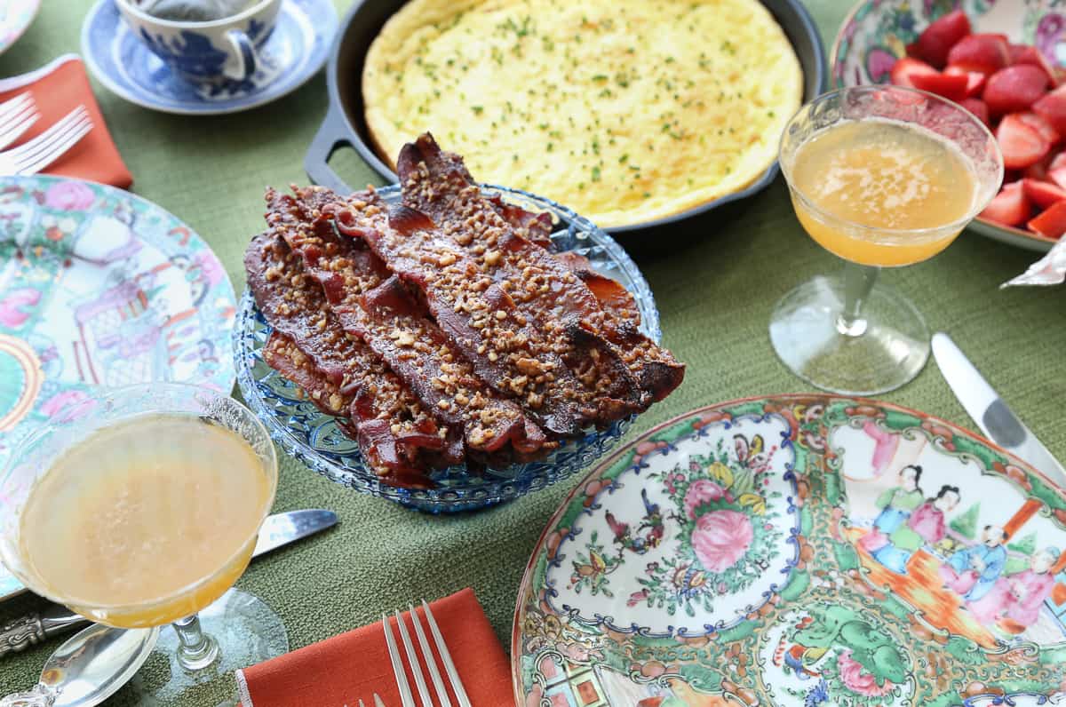 table set for brunch with praline candied bacon and spoon bread.