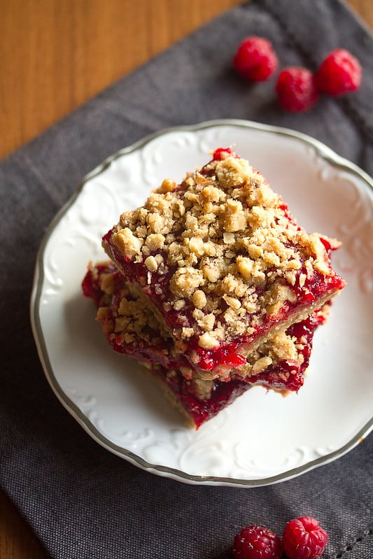 raspberry rhubarb crumble bars on a white plate.