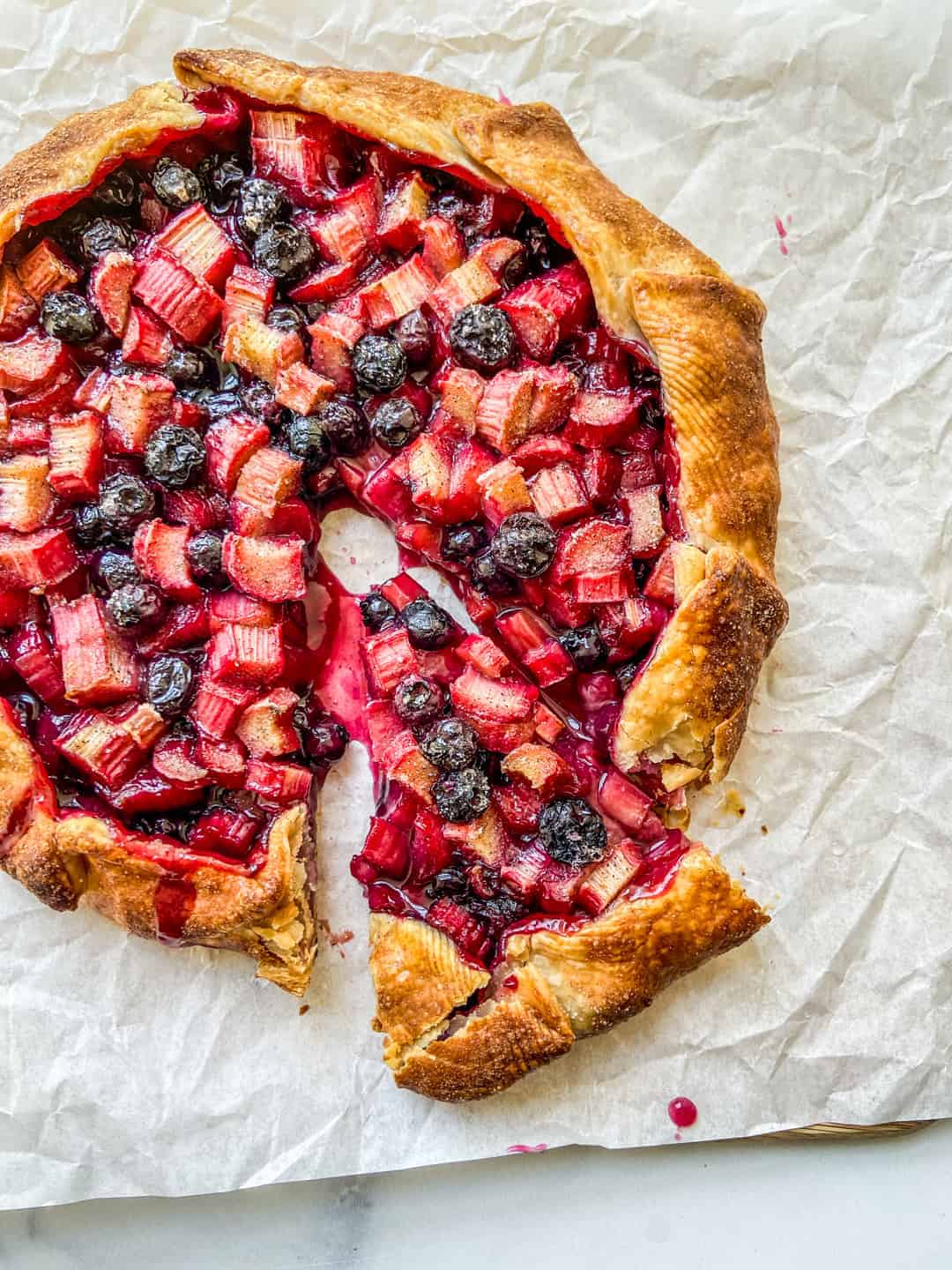 rhubarb blueberry galette on parchment paper.