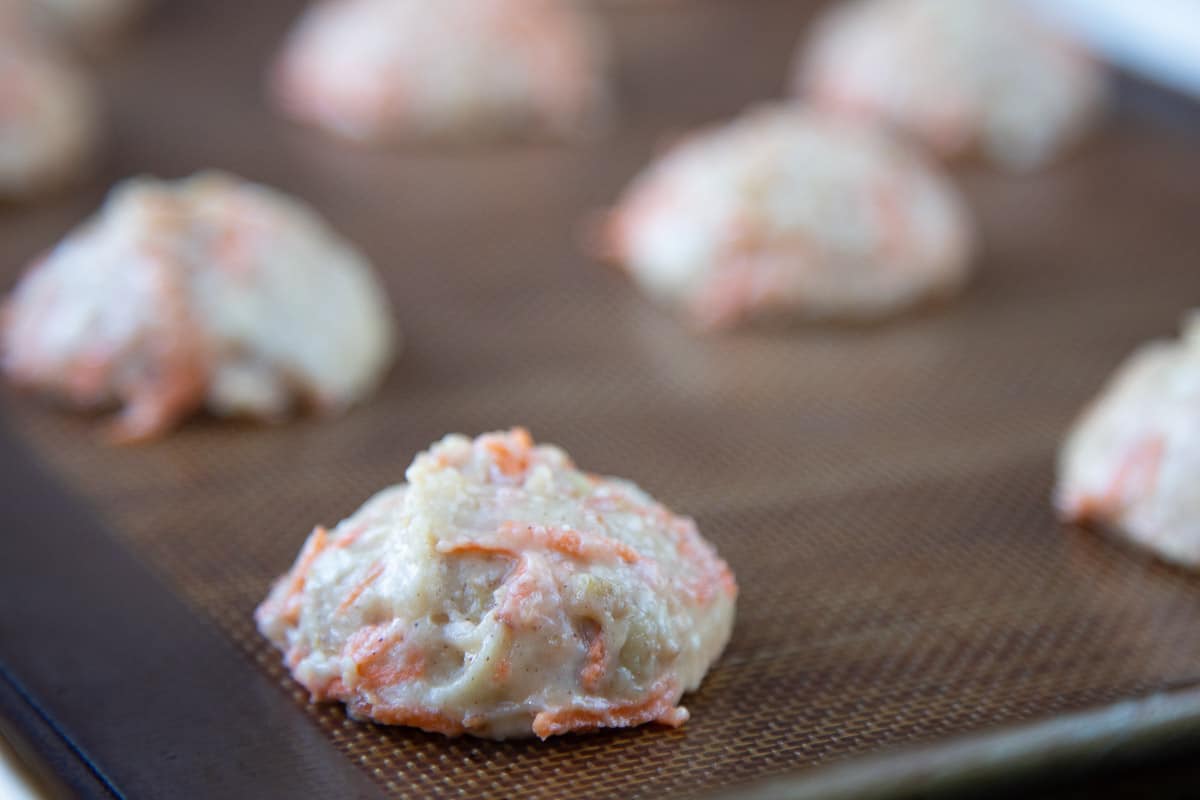 unbaked cake batter mounds on a baking sheet.