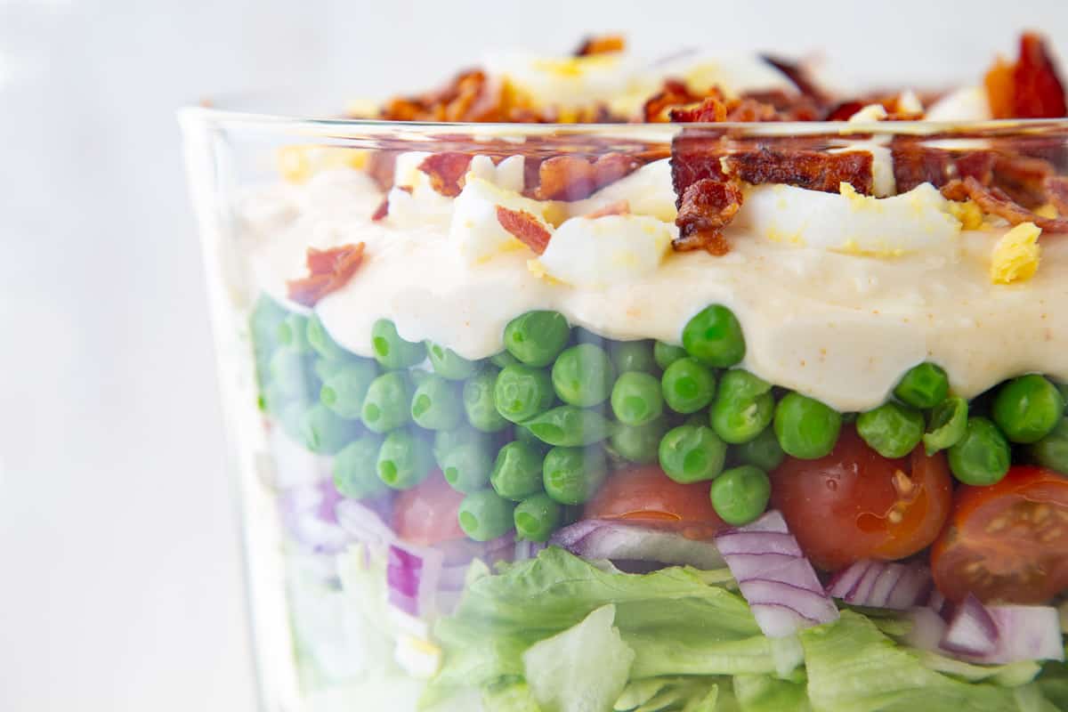 7 layer salad in a glass dish.