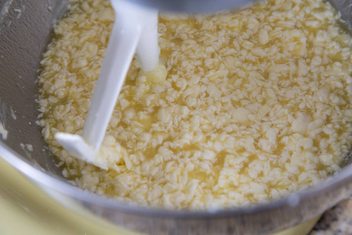 butter, sugar, eggs, and water in a stand mixer bowl.