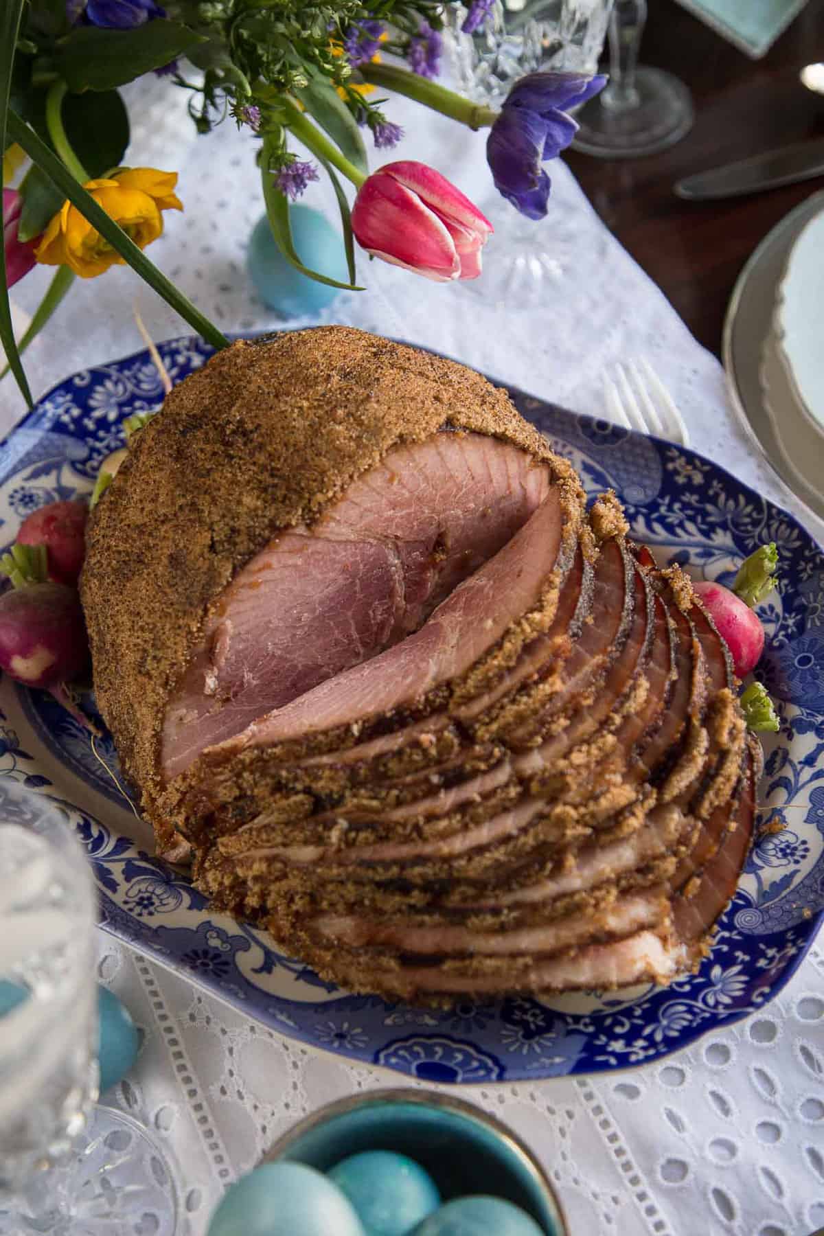 fire glazed spiral sliced ham on an easter table.