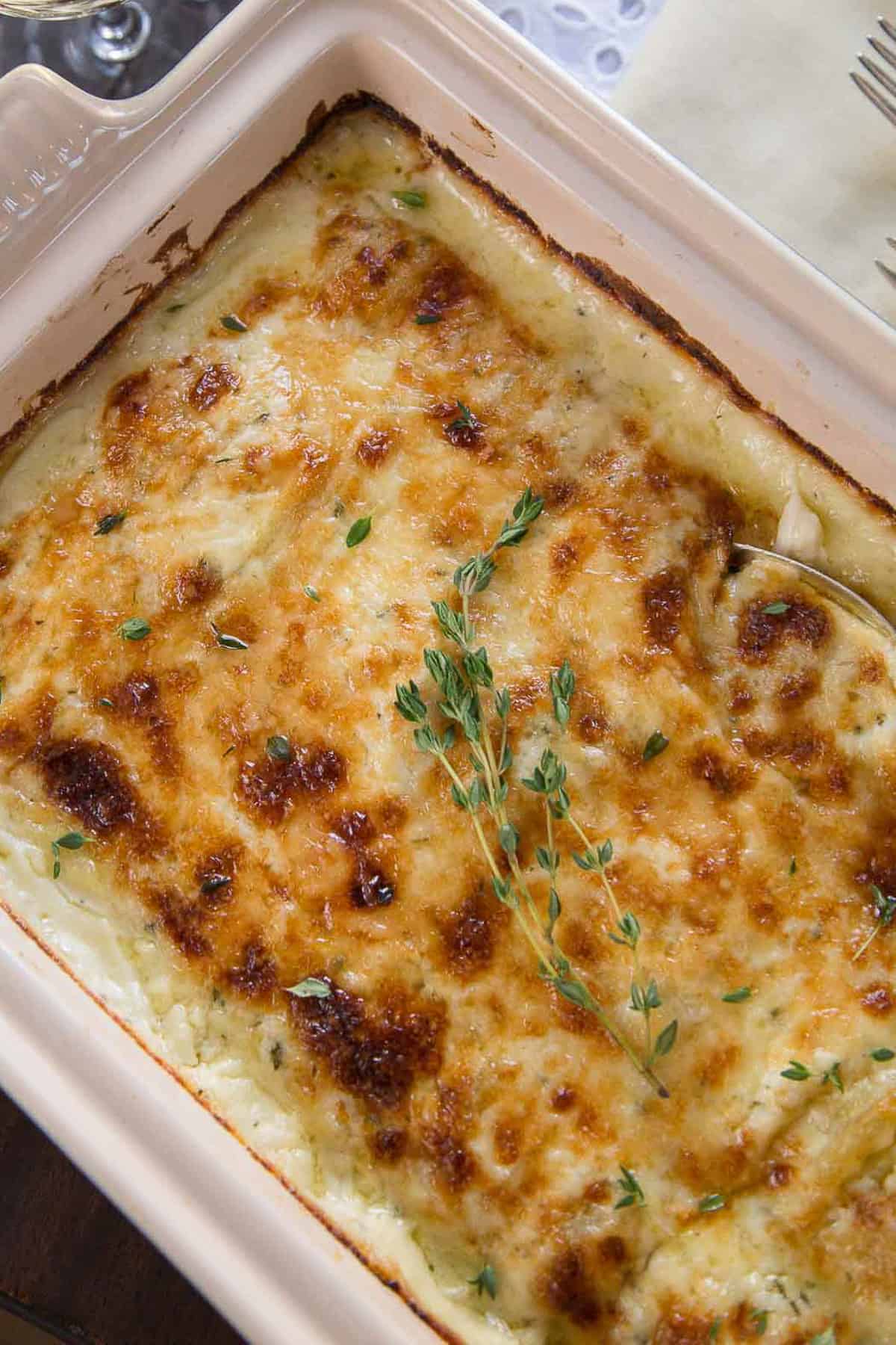 gruyere scalloped potatoes in a casserole dish.