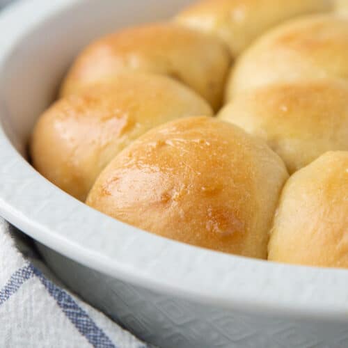 potato rolls in a round white dish.