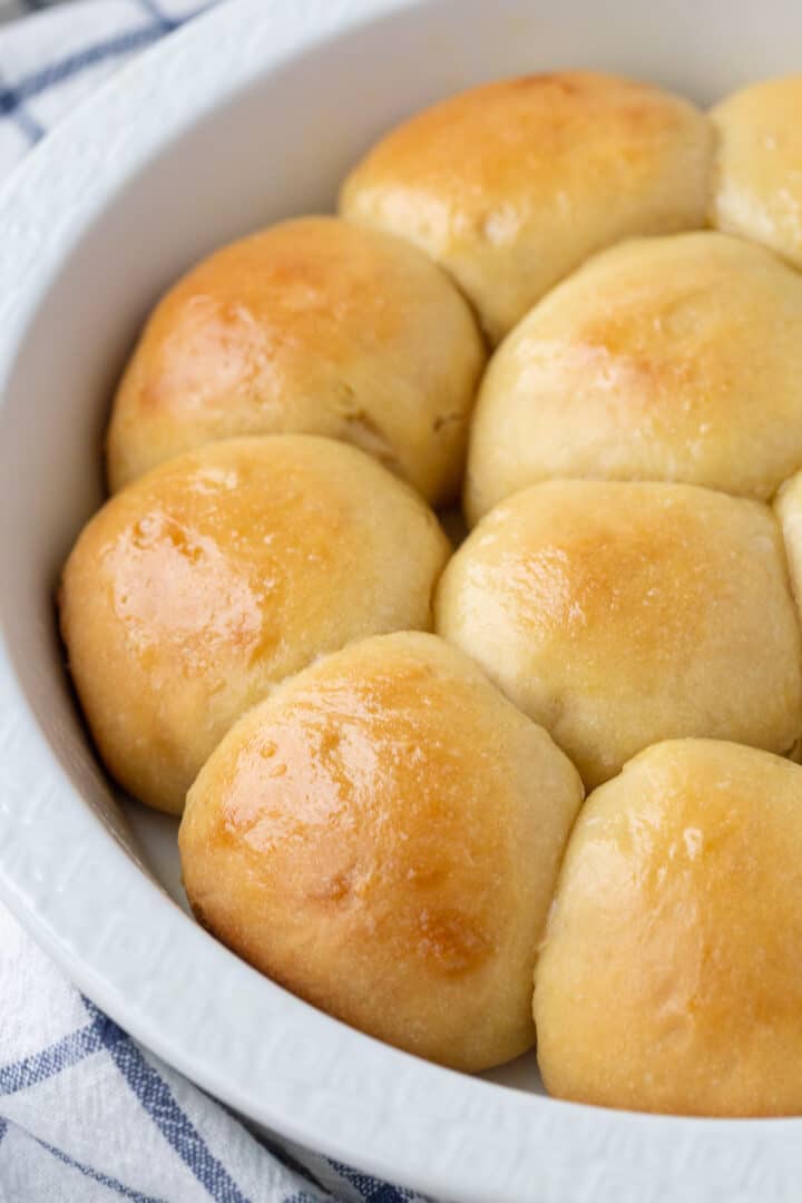 fluffy dinner rolls in a round cake pan.