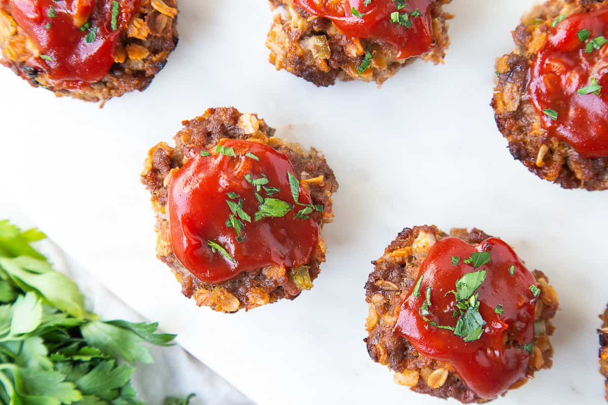 muffin tin meatloaves on a white platter.