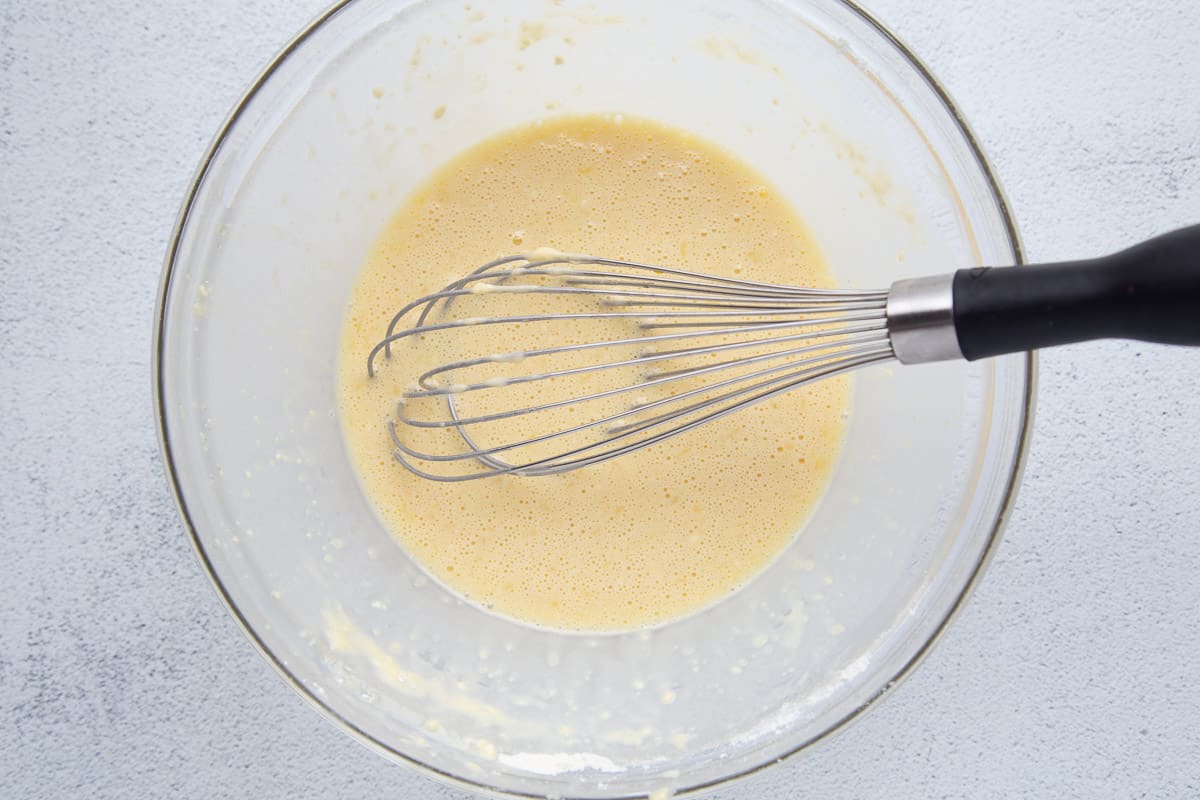 whisk in a glass bowl of pancake batter.