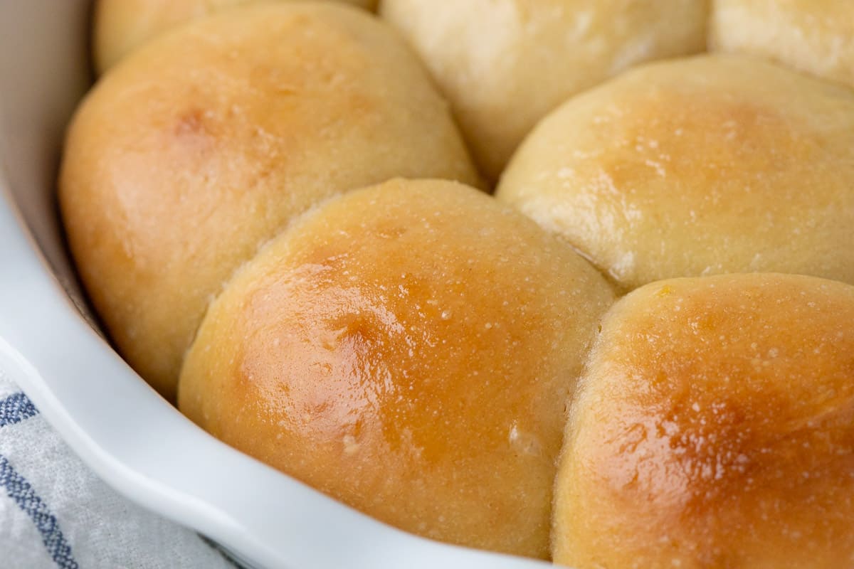 buttery dinner rolls in a white dish.
