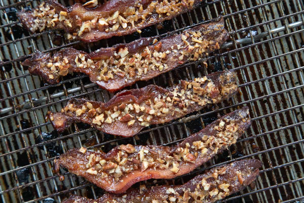 cooked praline candied bacon on a wire rack.