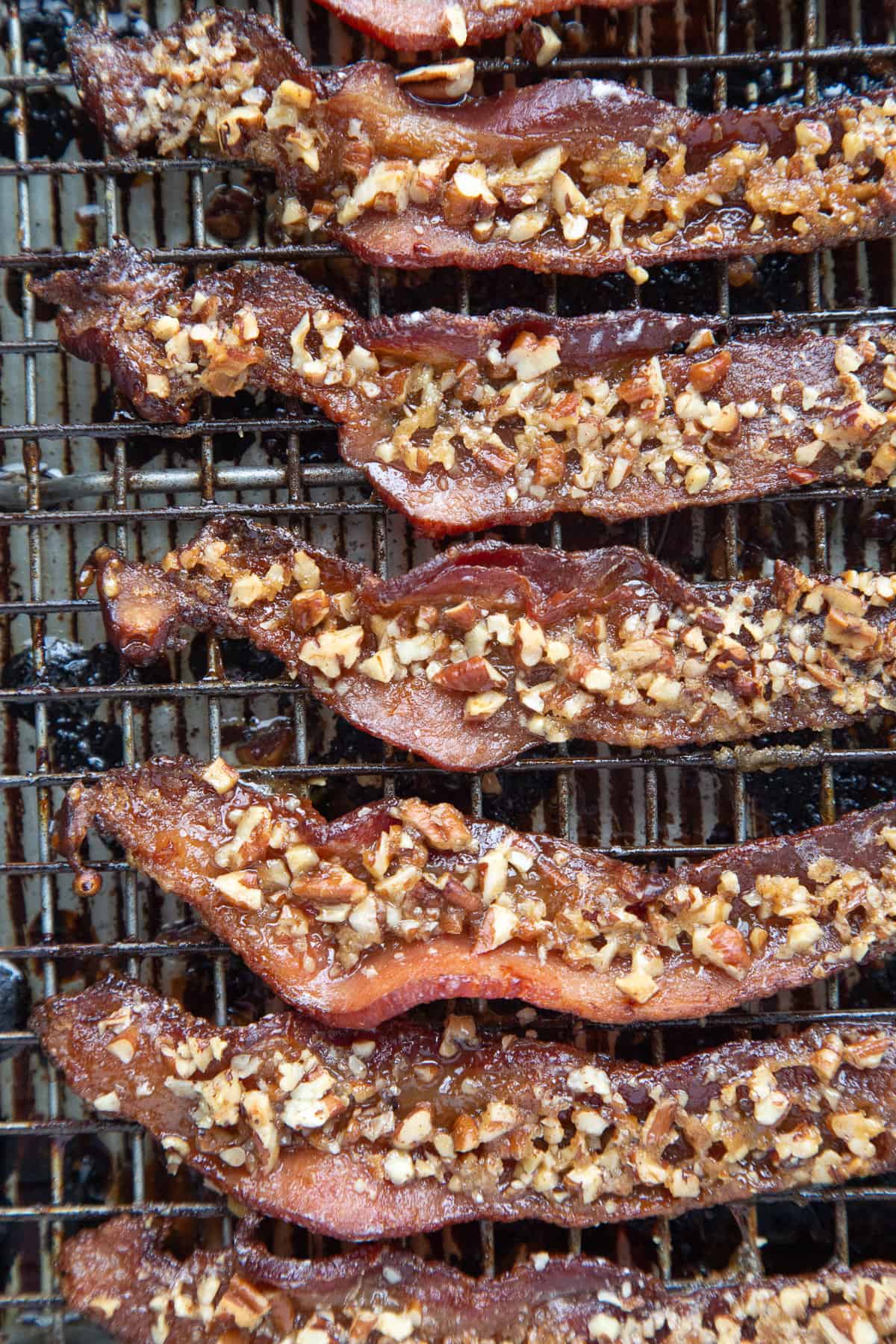 praline bacon lined up on a wire rack.
