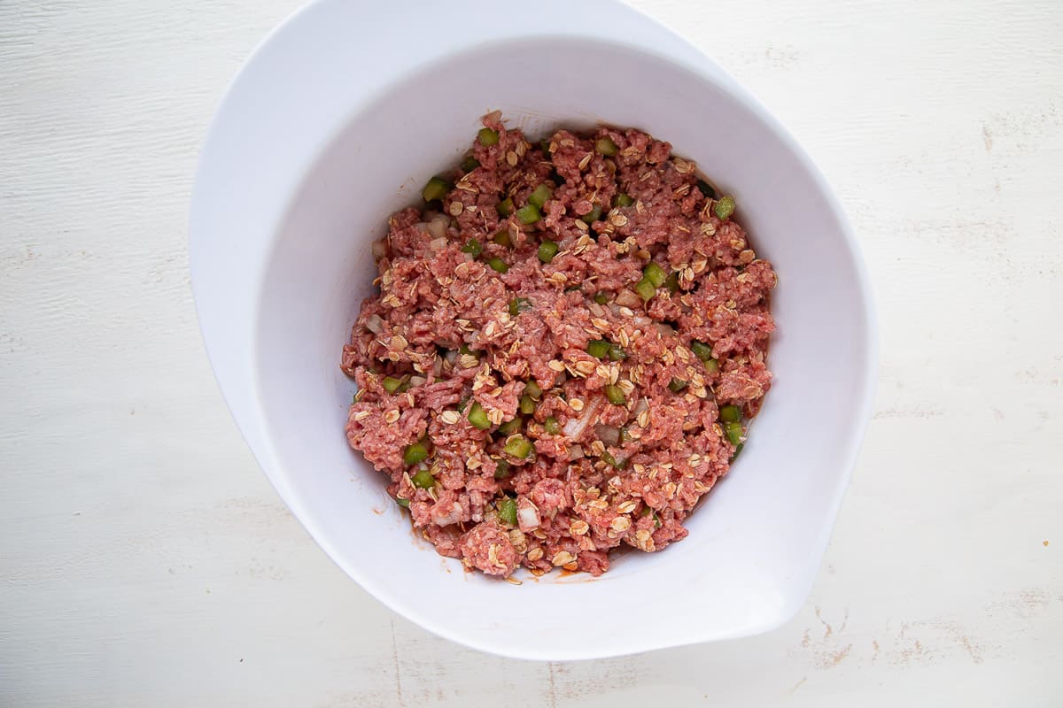 raw ground beef mixture in a white bowl.