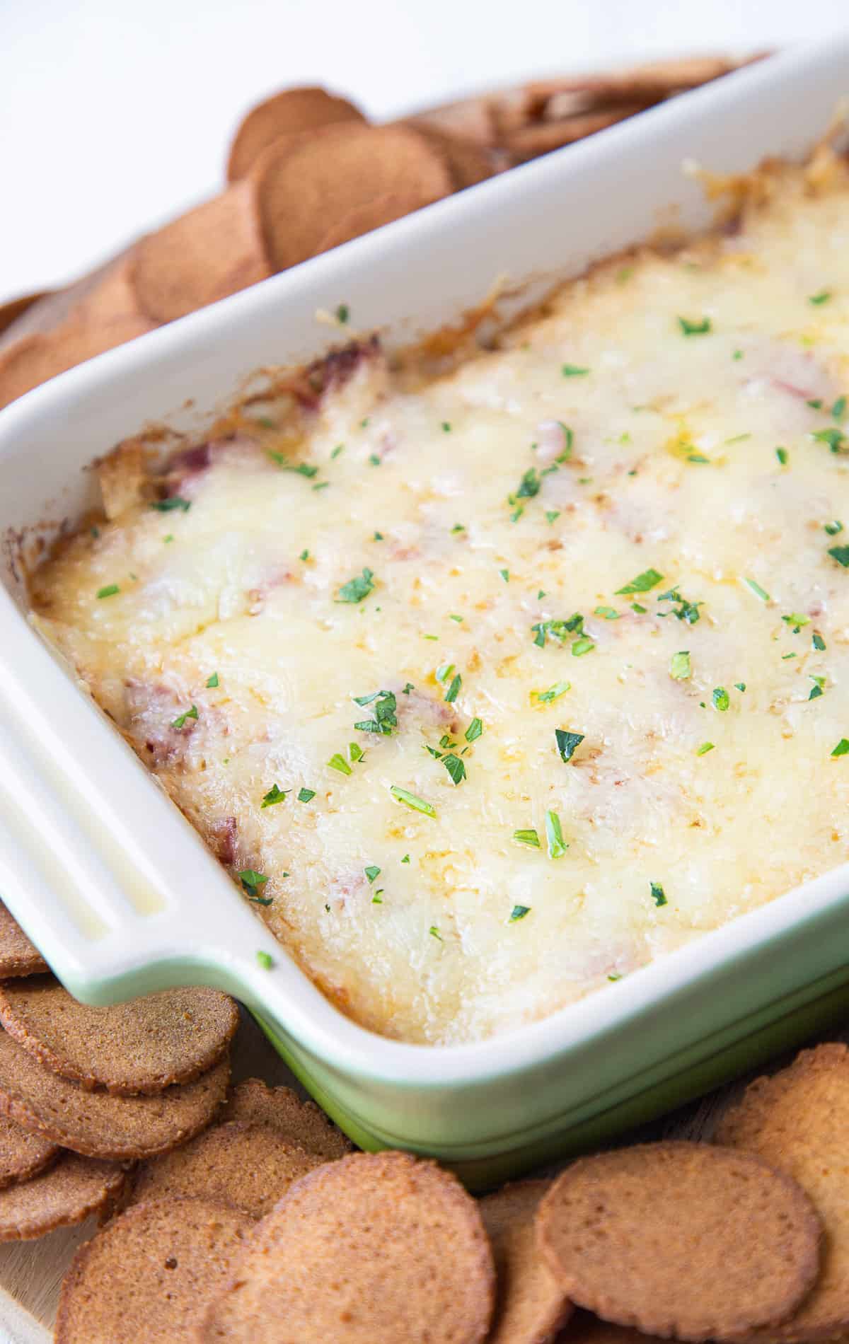 reuben dip next to rye crackers.