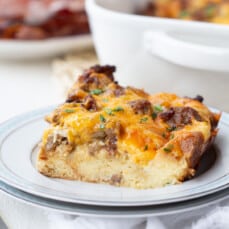 slice of sausage and egg casserole on a white plate.